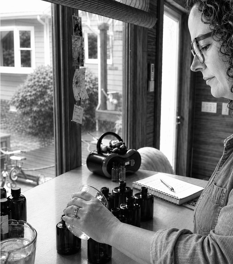 Lisa blending custom fragrances at the Deeper Roots candle shop